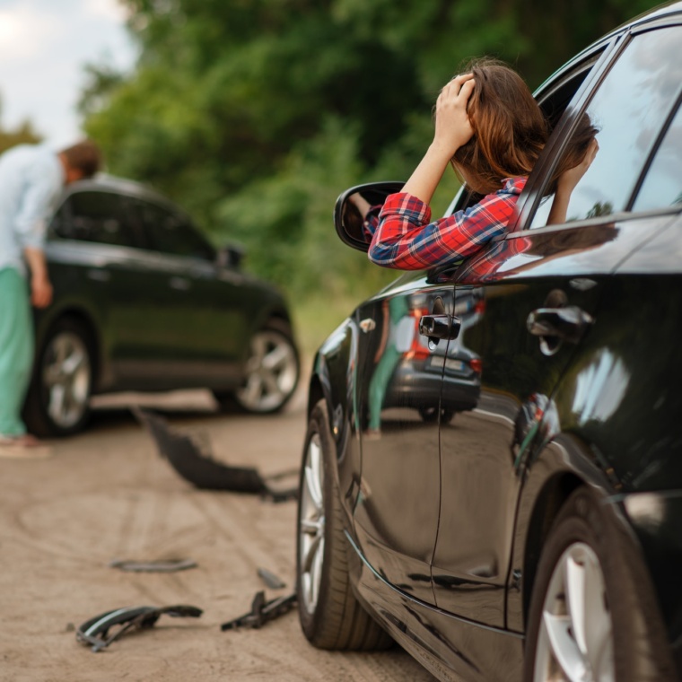 Male and female drivers after car accident on road